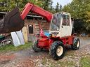 telescopico-manitou-con-forche-gancio-benna-e-benn
