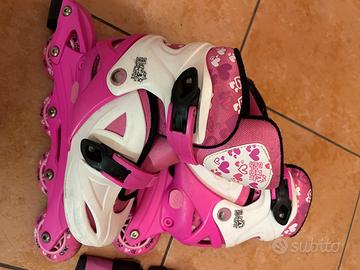 Pattini a rotelle rosa n. 31 + casco