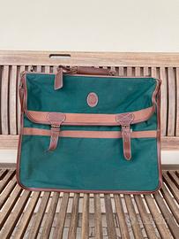 Valigia vintage verde con tracolla e rinforzo