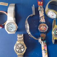 Sette orologi Swatch in blocco