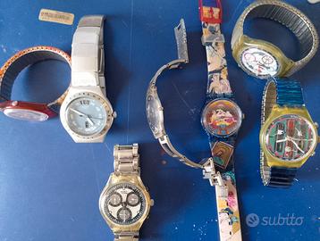 Sette orologi Swatch in blocco
