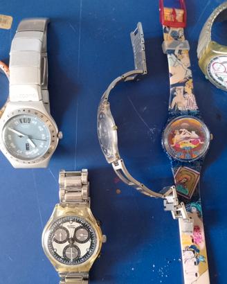 Sette orologi Swatch in blocco