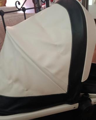 Carrozzina con rivestimento in pelle bianca