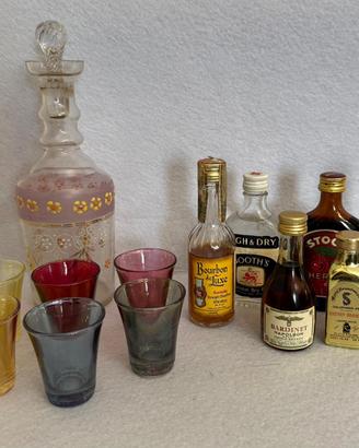 Bottiglia, bicchierini e bottigliette di liquore