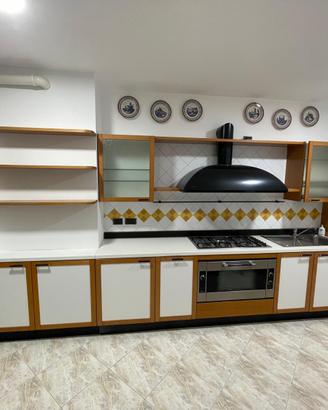 Cucina Binova con elettrodomestici, tavolo e sedie