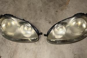 Coppia Fari Anteriori VW Golf 5 Originali Hella/AL