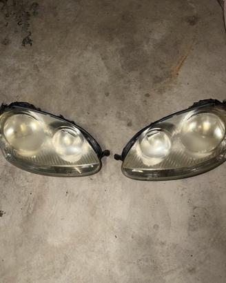 Coppia Fari Anteriori VW Golf 5 Originali Hella/AL