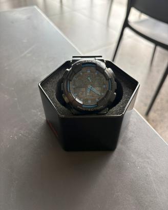 Casio G-Shock GA-100 nero/blu - con latta original
