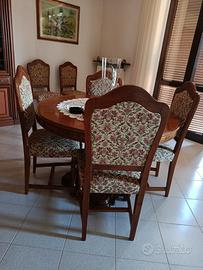 tavolo rotondo in legno tinta noce e 6 sedie.