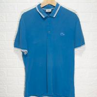 Polo Lacoste azzurra con profili bianchi L
