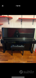 Pianoforte a muro nero laccato lucido.