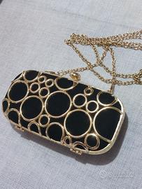 Clutch nera elegante con dettagli oro – Prima Donn