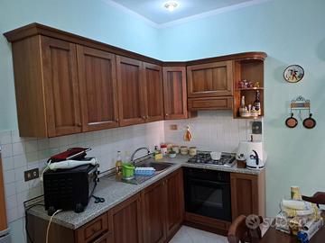 Cucina angolare in legno con top