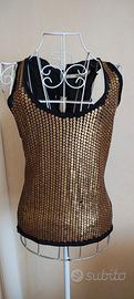 Top marca Gotha. paillettes color oro 