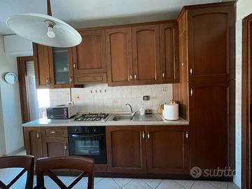 Cucina in legno con tavolo e sedie