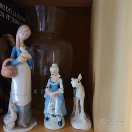 Statuine in ceramica e posacenere in cristallo.