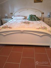 letto matrimoniale  con reti e un comodino 