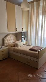 Letto singolo con testata in pelle