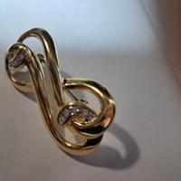 Spilla dorata vintage a nodo/infinito con strass –