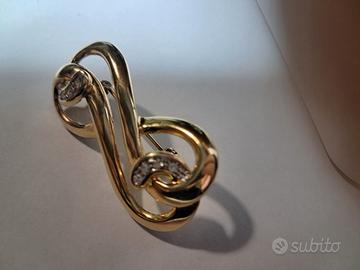 Spilla dorata vintage a nodo/infinito con strass –