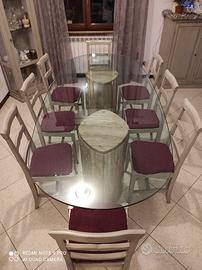 Tavolo con basi in travertino e piano in vetro