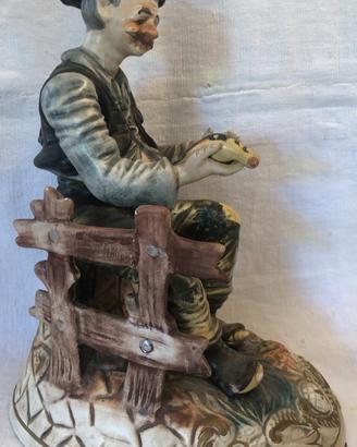 Statuetta ceramica uomo con uccellino
