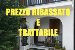Casa affiancata ad L in contesto collinare