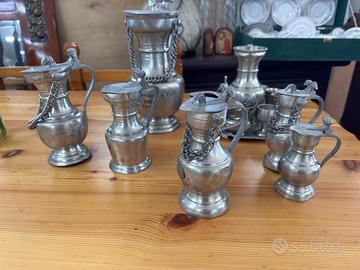 Due set brocche svizzere in peltro