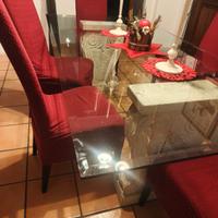 Tavolo in cristallo con basi in travertino 