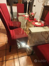 Tavolo in cristallo con basi in travertino 