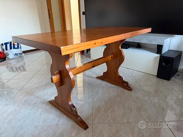 Tavolo in legno con due sedie e una panca