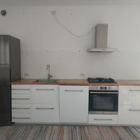 Cucina lineare bianco con piano cottura e lavello