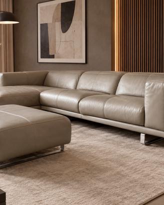 Divano design in pelle con penisola e pouf
