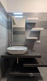 Mobile bagno con specchio, lavabo e rubinetto