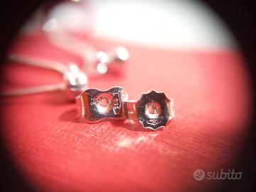 Orecchini oro bianco a ricciolo