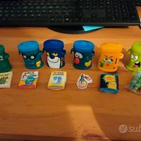 Lotto 11 bidoncini e orologio bidoni 