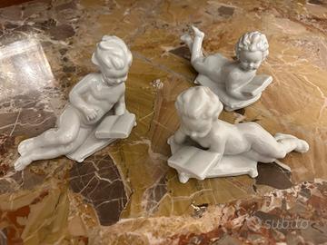 Soprammobile puttini in ceramica