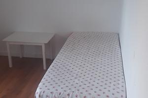 Bed in a single room