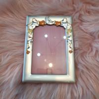 Cornice argento con disegni smaltati 