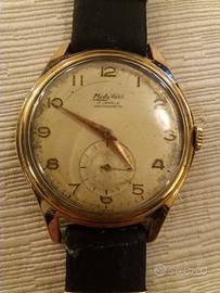 Antico orologio dorato cinturino pelle nera