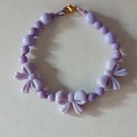 Braccialetto con perline e fiocchetti 