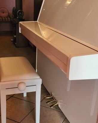 pianoforte bianco e sgabello da pianoforte