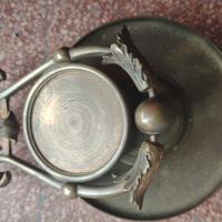 antico portaorologio basculante in bronzo.