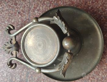 antico portaorologio basculante in bronzo.