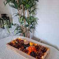 “Centrotavola autunnale con pigne, luci e decoraz