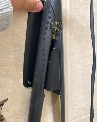 Riponi piastra per capelli che si attacca al muro