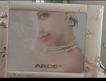 Cornice in argento Arde'