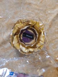 candela Point a la ligne su piatto in vetro dorato