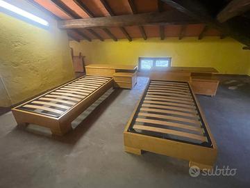 letti singoli con comodino e testiera contenitore