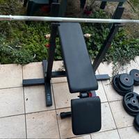 Panca piana con bilanciere e pesi